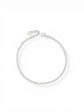 Bracciale tennis sottile 1.5mm in argento 925 con zirconi bianchi taglio brillante e chiusura a moschettone con catenella di estensione su sfondo bianco.
